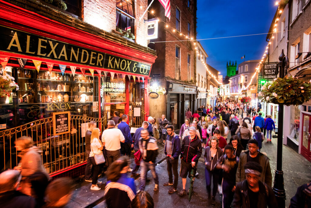 People walking down a road in Ennis at night