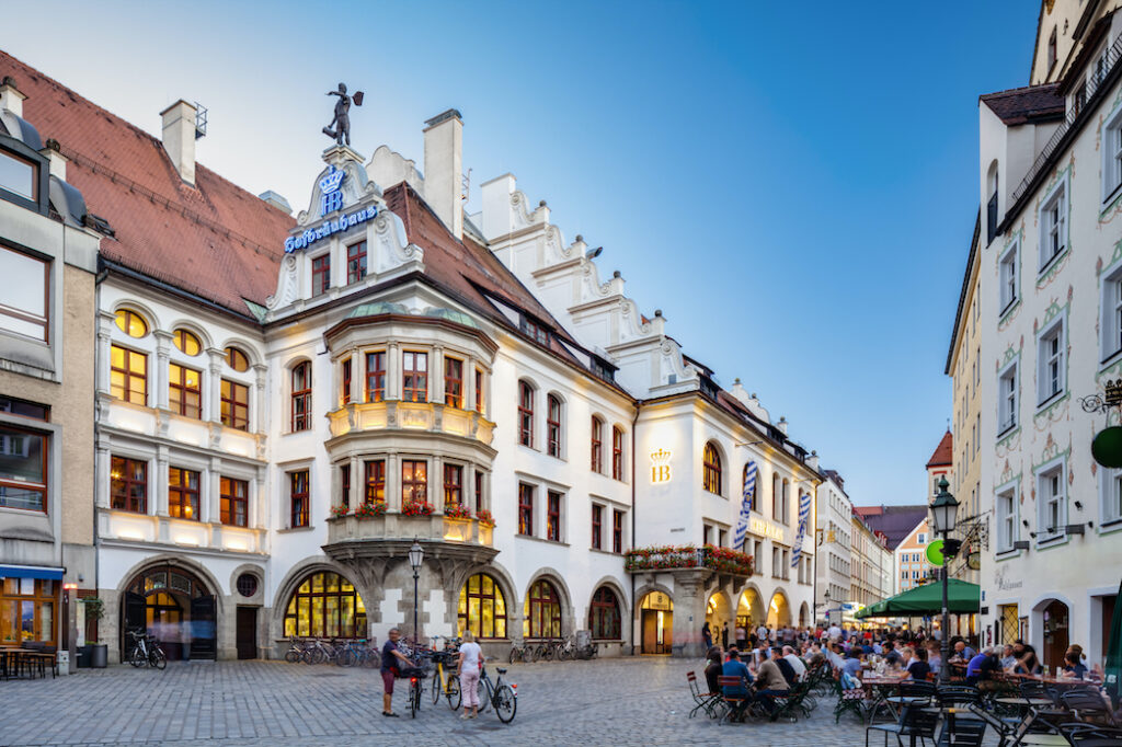 Historic buildings of Munich with a courtyard in foreground and blue sky in background