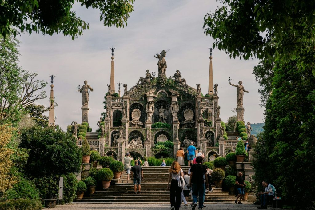 A group of people walking up a set of stairs to a historic monument