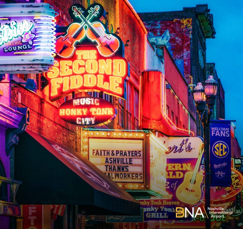 Neon signs, lights and billboards advertising music and events in a busy city entertainment district