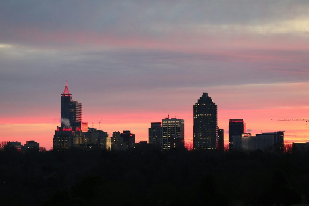 Raleigh's skyline with a sunset sky in the background
