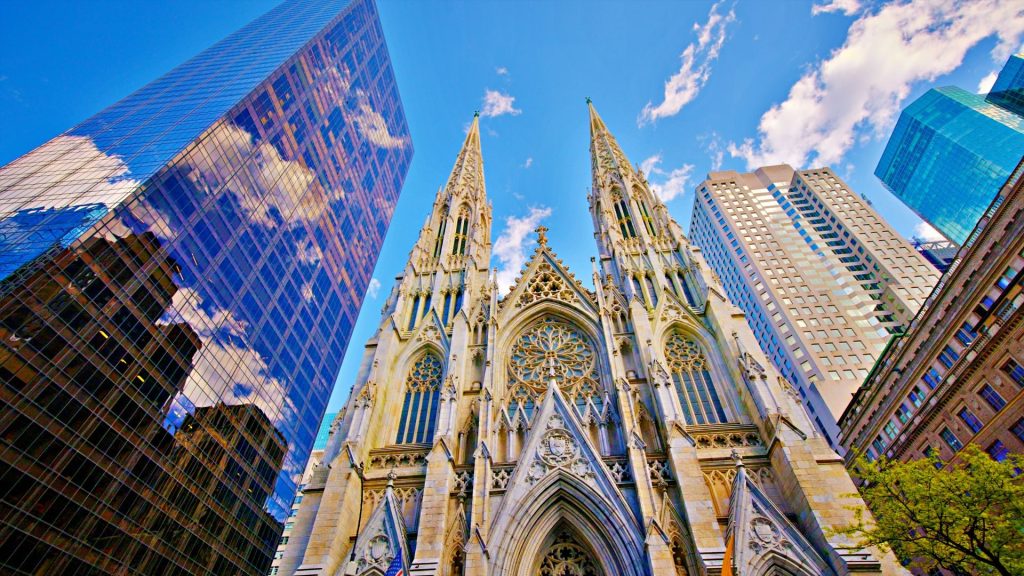 St. Patrick's Cathedral, skyscrapers and blue sky in New York City, USA