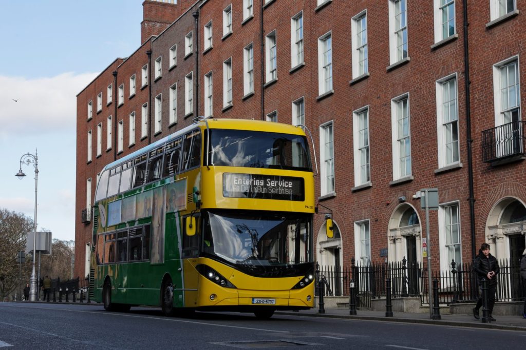 Dublin Bus with red brick buildings