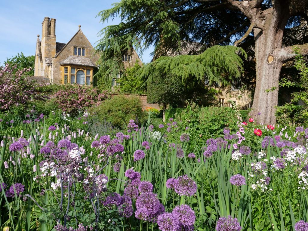 Summer border full of alliums in Hidcote Manor and Garden, National Trust property, in the Cotswolds