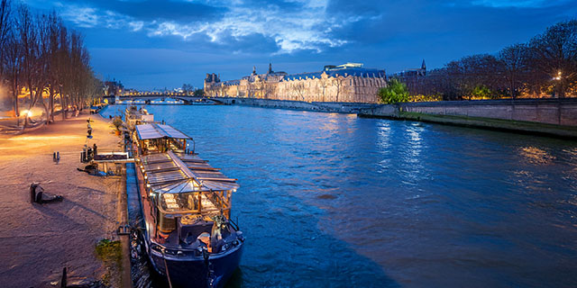 Boats moored along the Seine in Paris at dusk