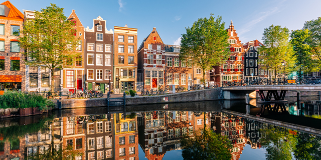 Traditional Dutch houses along the canal on a sunny morning, Amsterdam, Netherlands