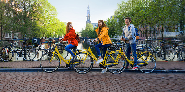 Group of friends on bicycles on an Amsterdam bridge