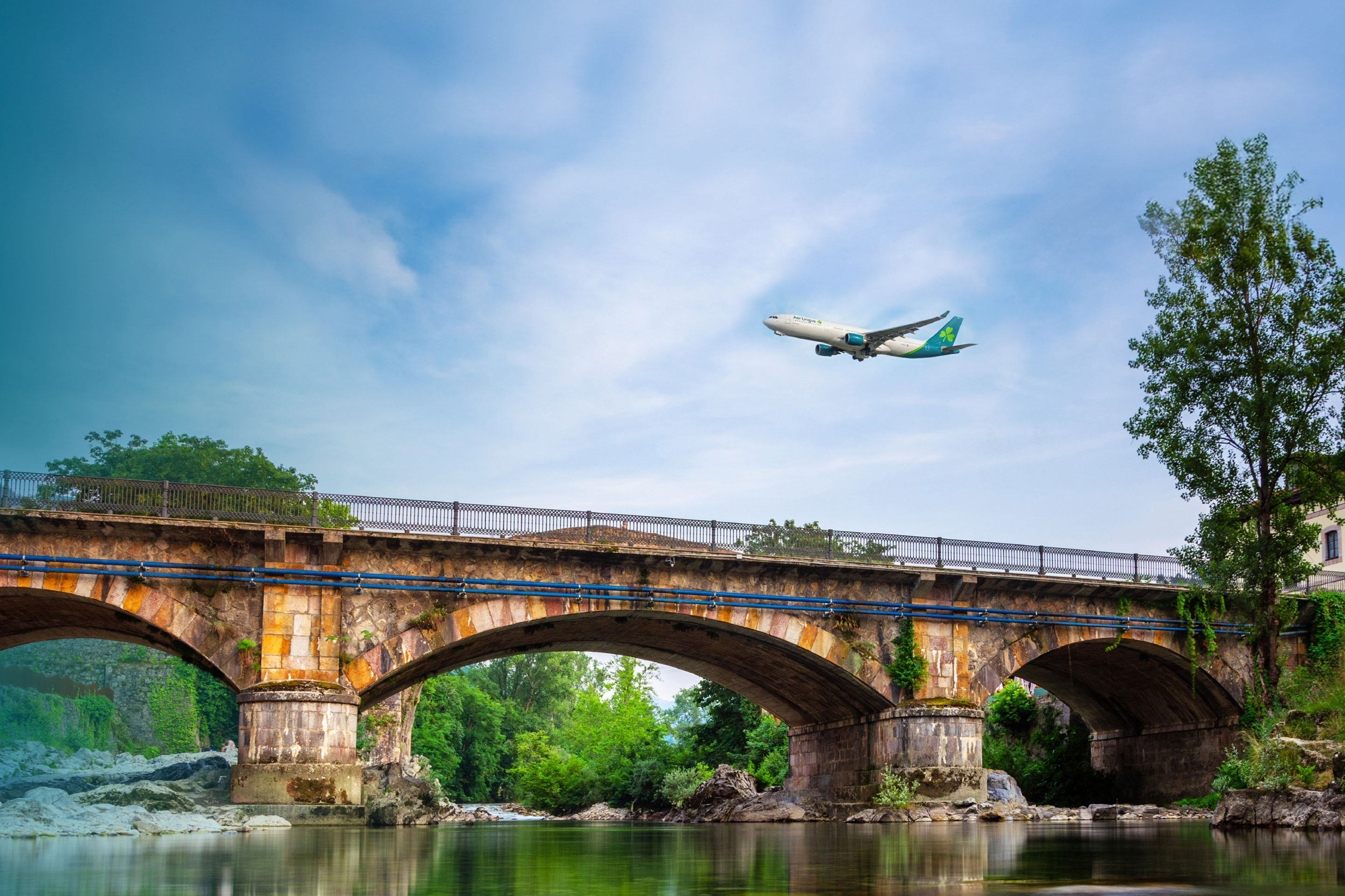 Aer Lingus plane flying above bridge in Asturias, Spain