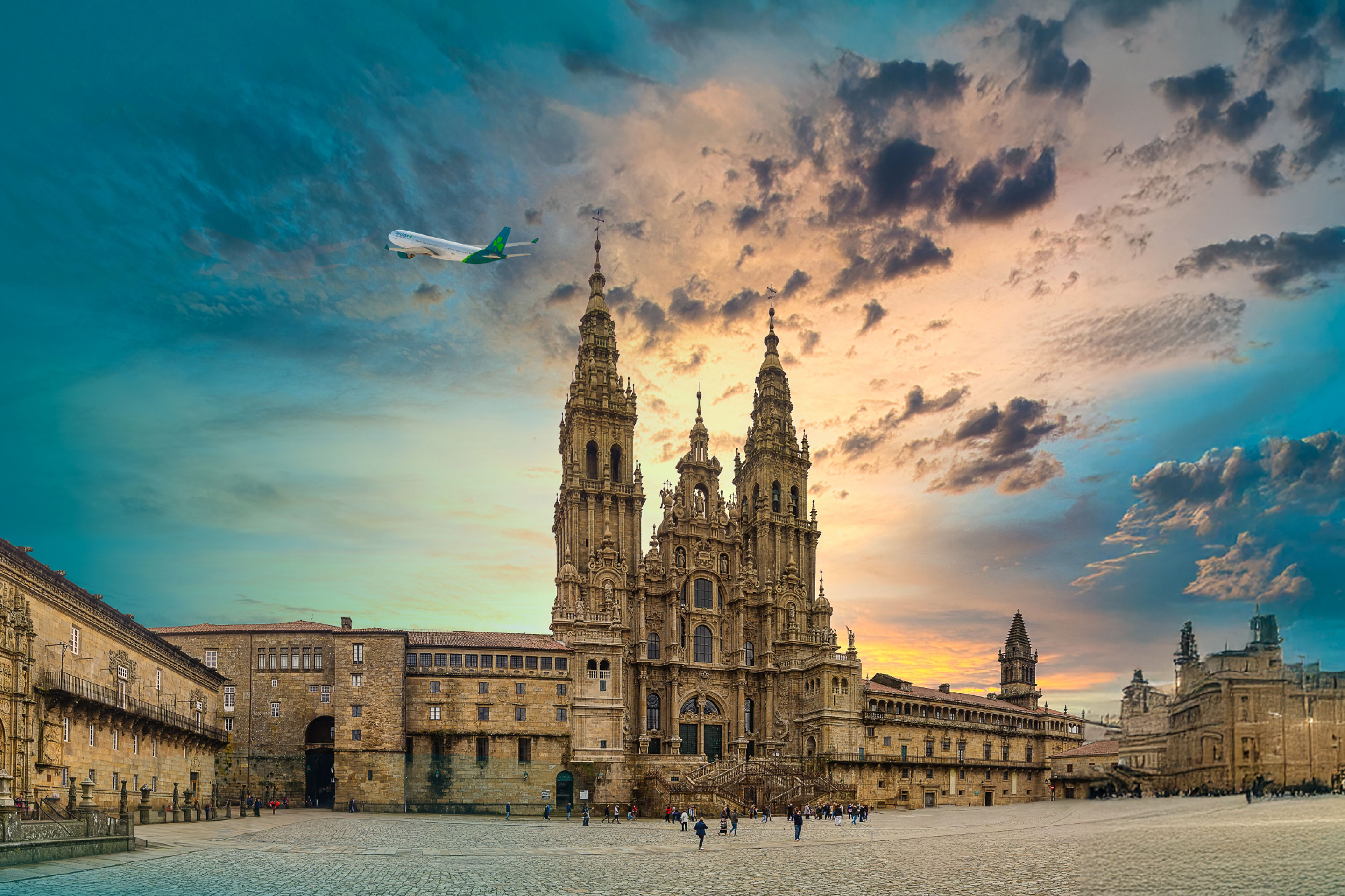Aer Lingus plane flying above cathedral in Santiago de Compostela, Spain at dusk