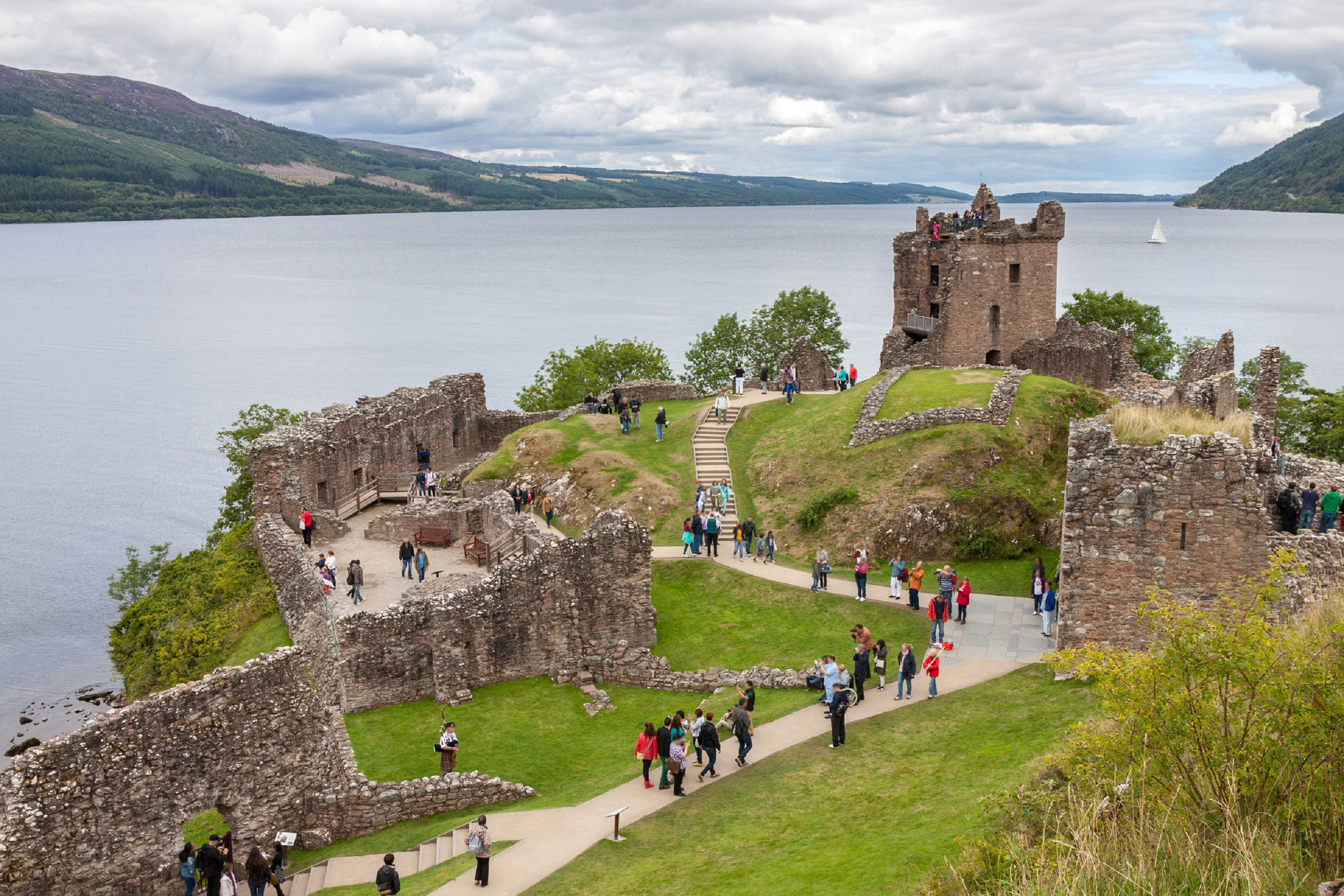 Tourists exploring Urquhart Castle at Loch Ness, Scotland