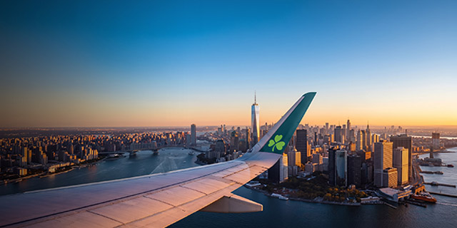 Manhattan skyline with wingtip of Aer Lingus aircraft