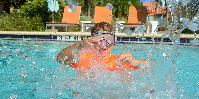 Boy playing in swimming pool